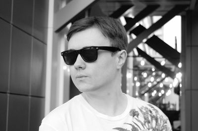 Portrait of young man wearing sunglasses standing outdoors
