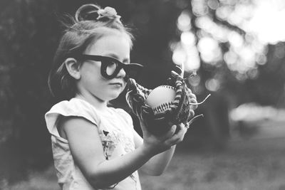 Portrait of girl holding sunglasses