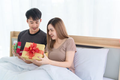 Young couple sitting outdoors