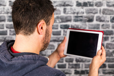 Portrait of young man using mobile phone