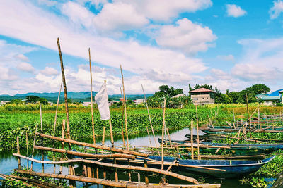 Boats moored in lake against sky