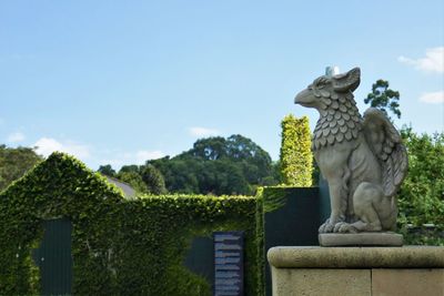 Statue against trees and sky