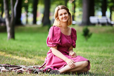 Portrait of smiling woman sitting outdoors