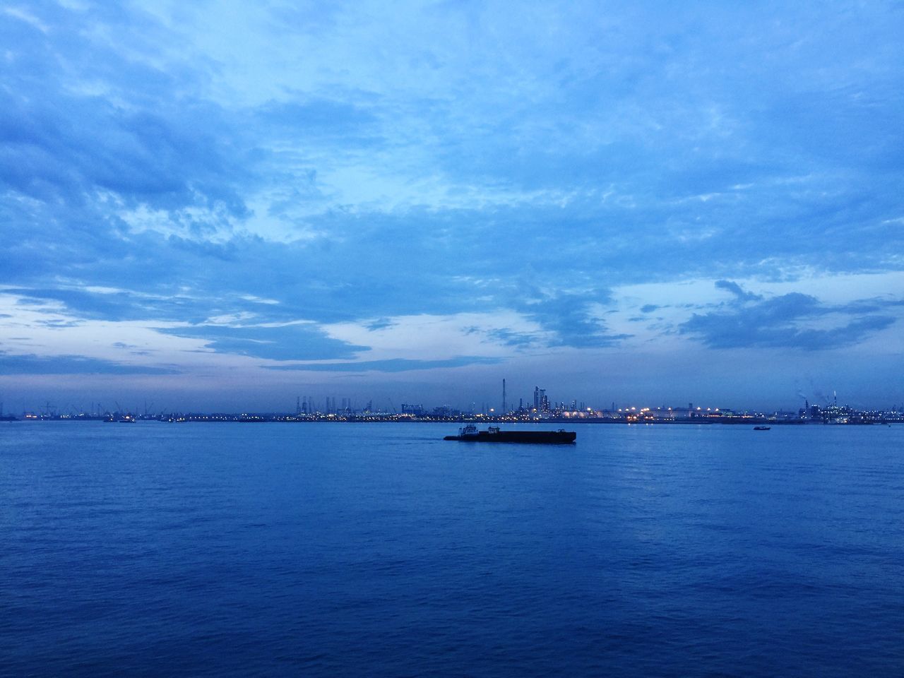 water, sea, waterfront, sky, tranquil scene, tranquility, scenics, blue, cloud - sky, beauty in nature, nature, dusk, cloud, rippled, built structure, transportation, idyllic, outdoors, cloudy, sunset