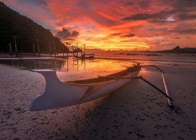 Scenic view of beach against sky during sunset