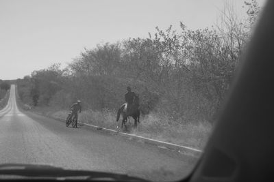 Man on road against sky