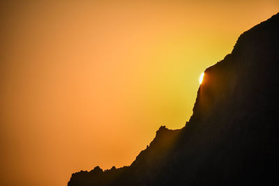 Low angle view of silhouette mountain against sky during sunset