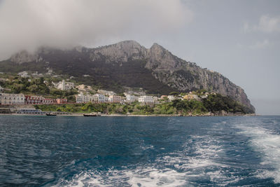 Scenic view of sea and mountains against sky