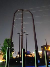 Low angle view of illuminated buildings against sky at night