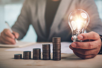 Close-up of hand holding light bulb
