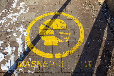 High angle view of yellow sign on street