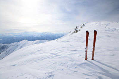 Scenic view of snow covered field against sky