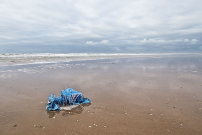 Umbrella on beach against sky