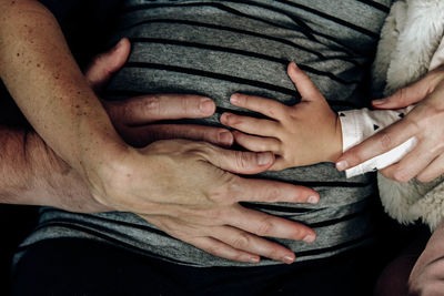 Midsection of woman with hands on stomach