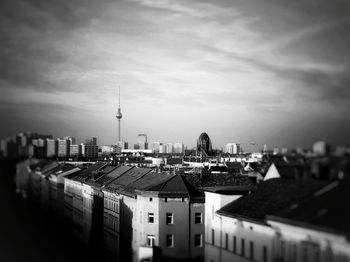 Cityscape against cloudy sky