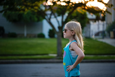 Side view of girl standing outdoors