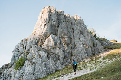 Low angle view of woman hiking in a rocky environment