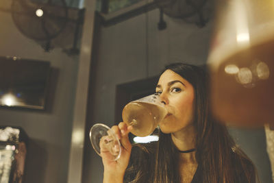 Young woman drinking glass