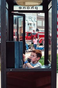 Boy using pay phone