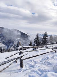 Snow covered landscape against sky