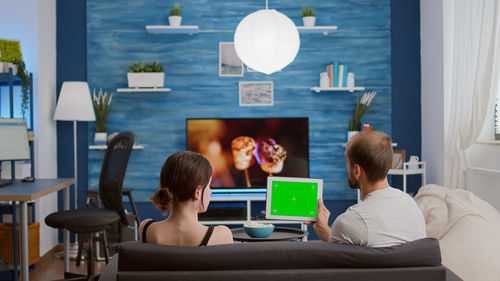 Couple with digital tablet at home