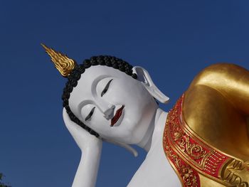 Low angle view of statue against blue sky