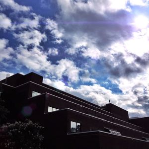 Low angle view of building against cloudy sky