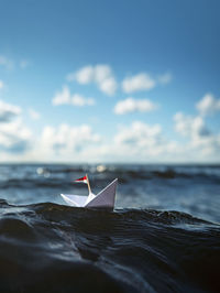 Paper boat in big waves