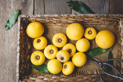 High angle view of fruits in basket on table