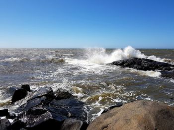 Scenic view of sea against clear blue sky