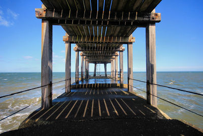 Pier over sea against clear sky