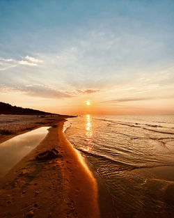 Scenic view of beach against sky during sunset