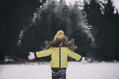 Girl playing with snow