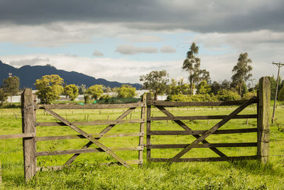 Fence on field against sky