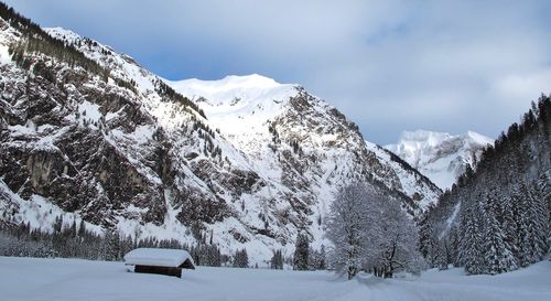 Scenic view of snowcapped mountains against sky during winter