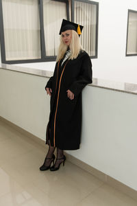 Full length of woman wearing graduation