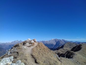 Scenic view of mountains against clear blue sky