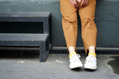 Low section of man sitting on bench