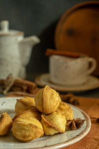A plate of cookies on a blurred background with a cup of fragrant coffee