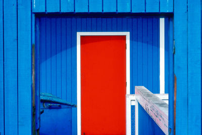 Red door on blue building