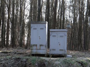 Garbage bin by trees in forest