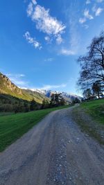 Empty road along countryside landscape