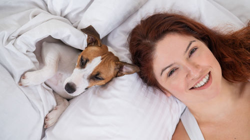 Close-up of young woman with dog