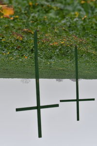 Cross on field against sky