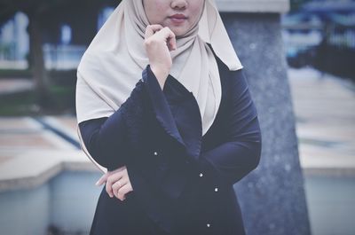 Midsection of woman standing outdoors