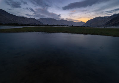 Scenic view of lake against sky during sunset