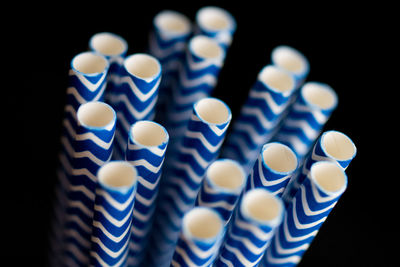 Close-up of illuminated lighting equipment against black background