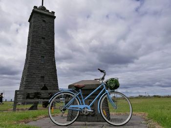 Bicycle on field against sky