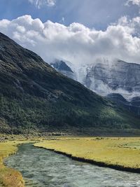 Scenic view of river amidst mountains against sky