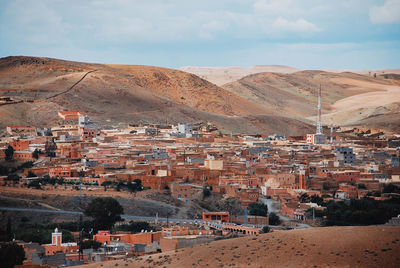 High angle view of buildings in town against sky